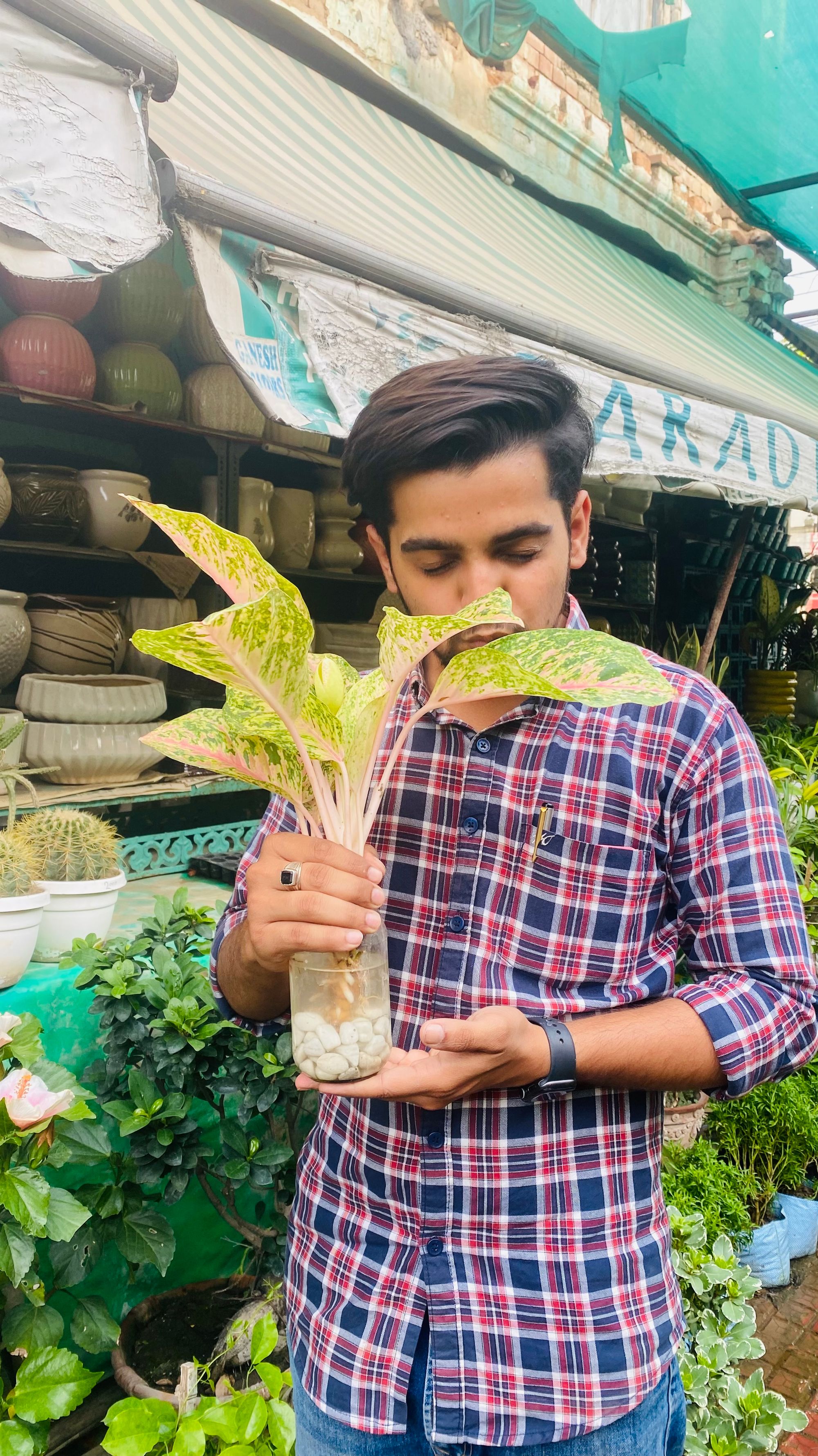 Anmol Rajput with a plant.